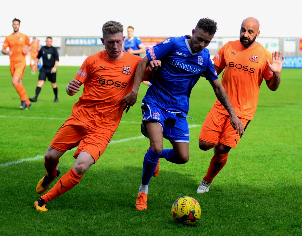 Ryan Campbell holds off two Hartley players