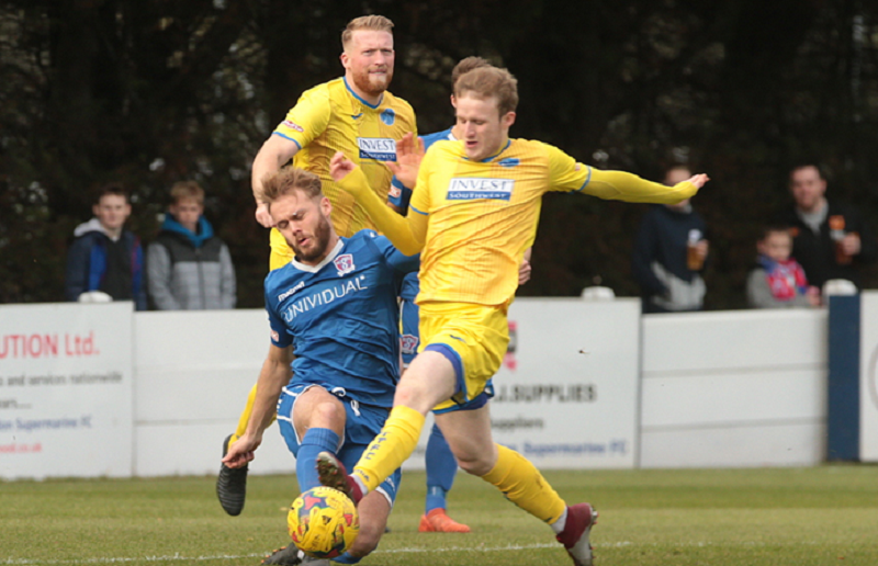 Matt Williams challenges Taunton’s Ollie Chamberlain in there last visit to the Webbswood