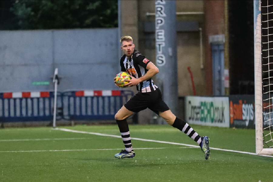 Kieran Douglas is eager to restart the game after scoring a last minute third goal for Dorchester