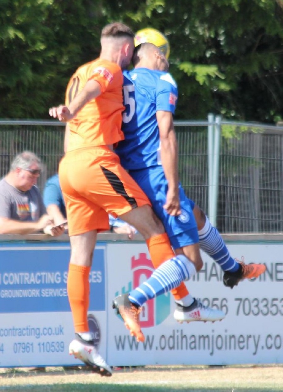 Tyrone Duffus gets up to win the header before the Hartley player