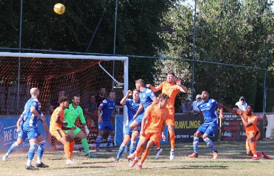 Hartley pressurise the Marine defence from a corner