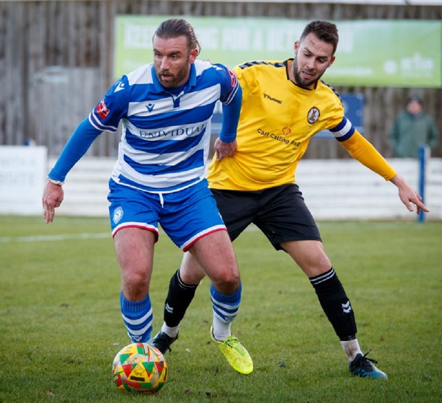 Conor McDonagh voted fans player of the match and former Marine player Michal Hopkins tussle for the ball