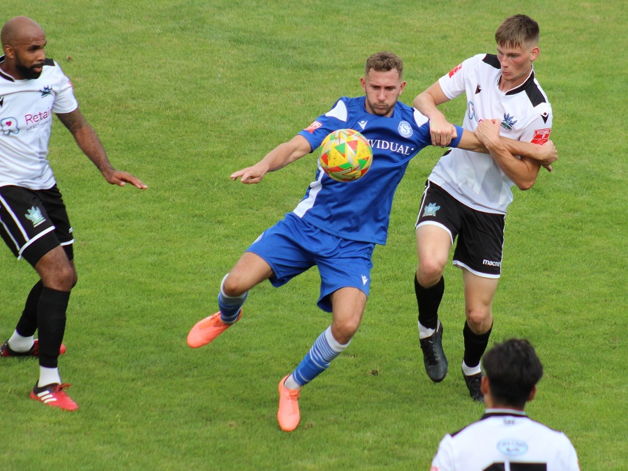 Harry Williams shields the ball from the Salisbury defender