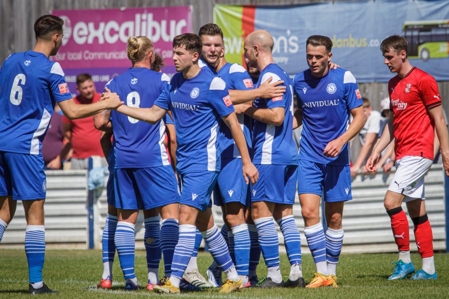 The players congratulate Hards’ on his opening goal