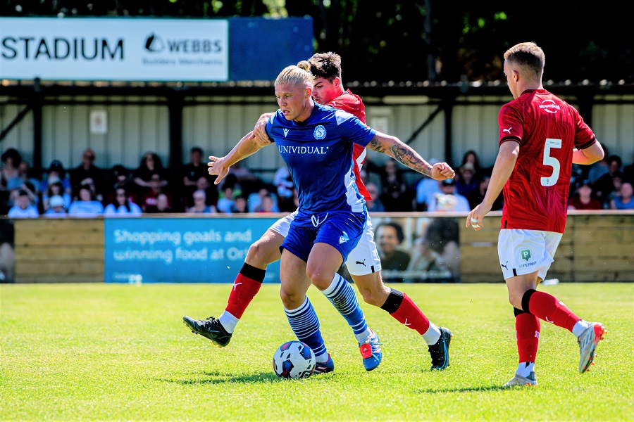 George Dowling gets past a couple of Town players