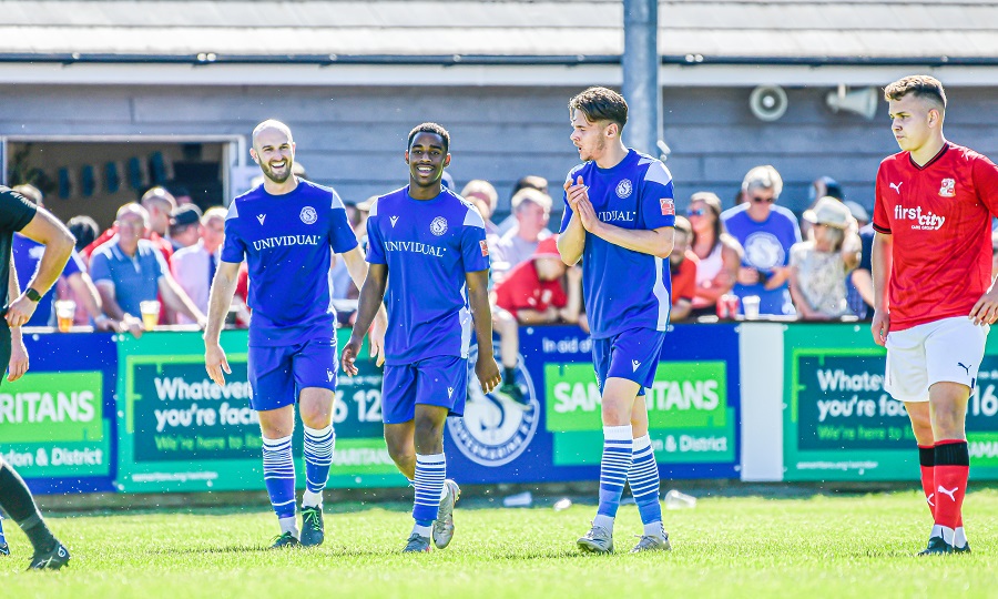 A couple of players celebrate Marine’s second goal with the goalscorer