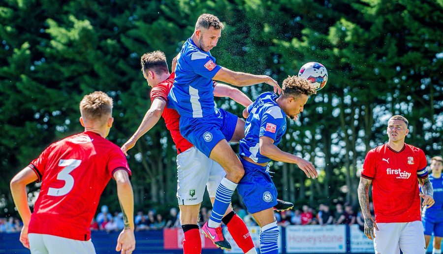 Harry Williams gets up the highest to win this header