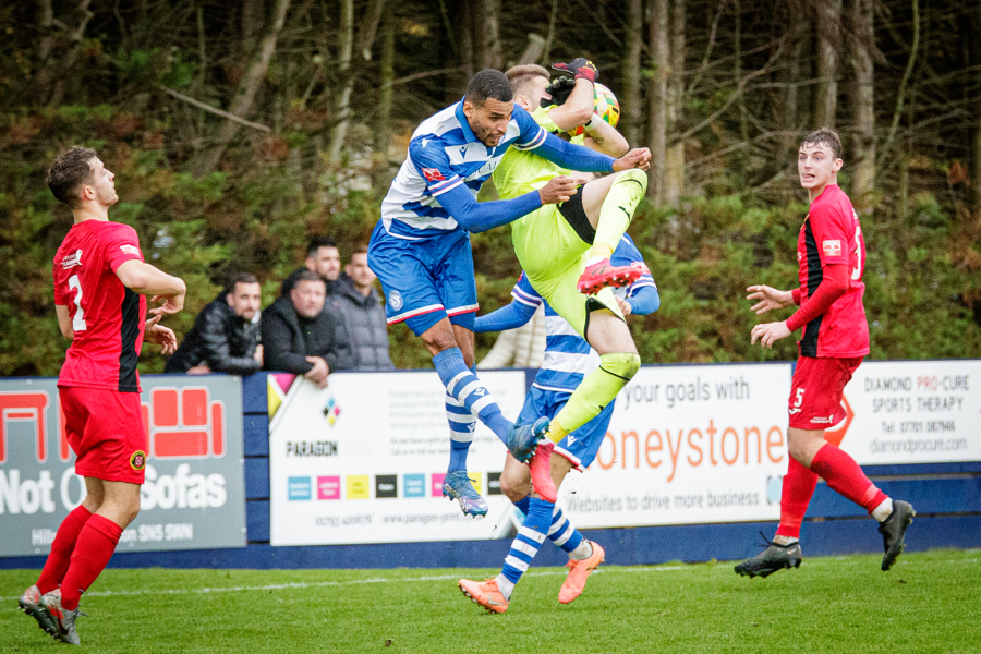 Tyrone Duffus goes up and challenges Winchester keeper Jordi Valero