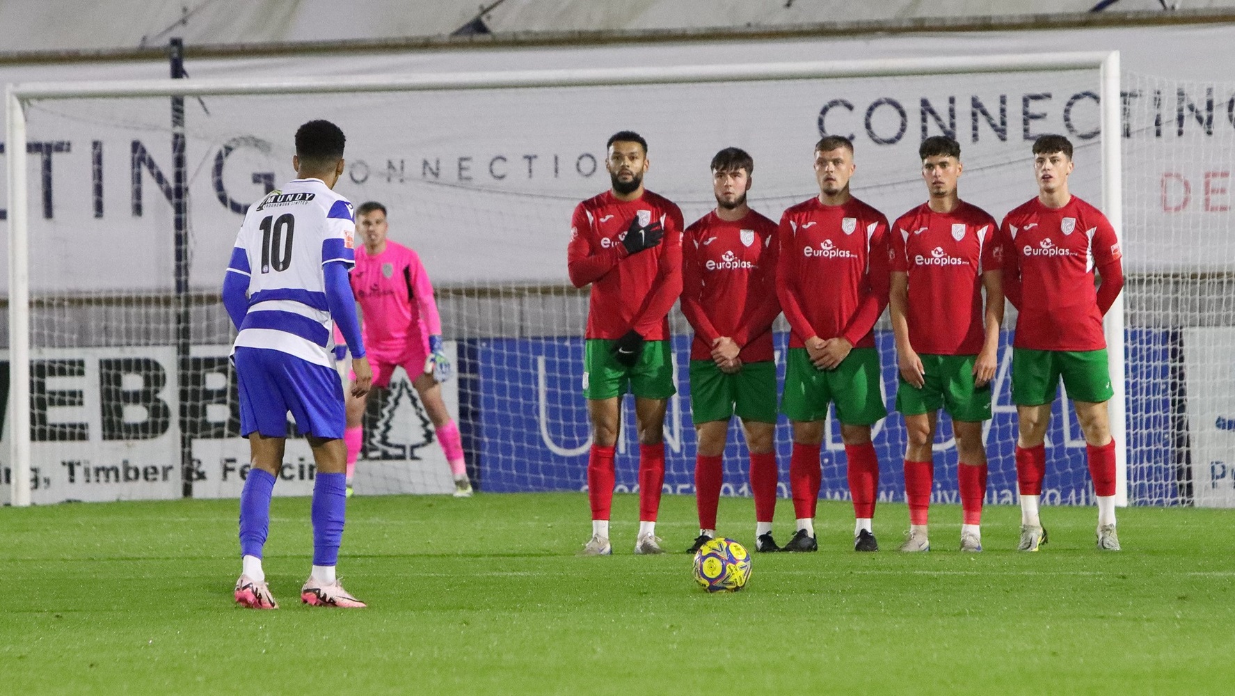 Michael Fernandes hits his free kick into the Merthyr wall