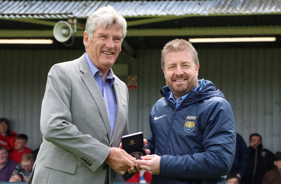 Steve Moore receives an award from the Wilts FA