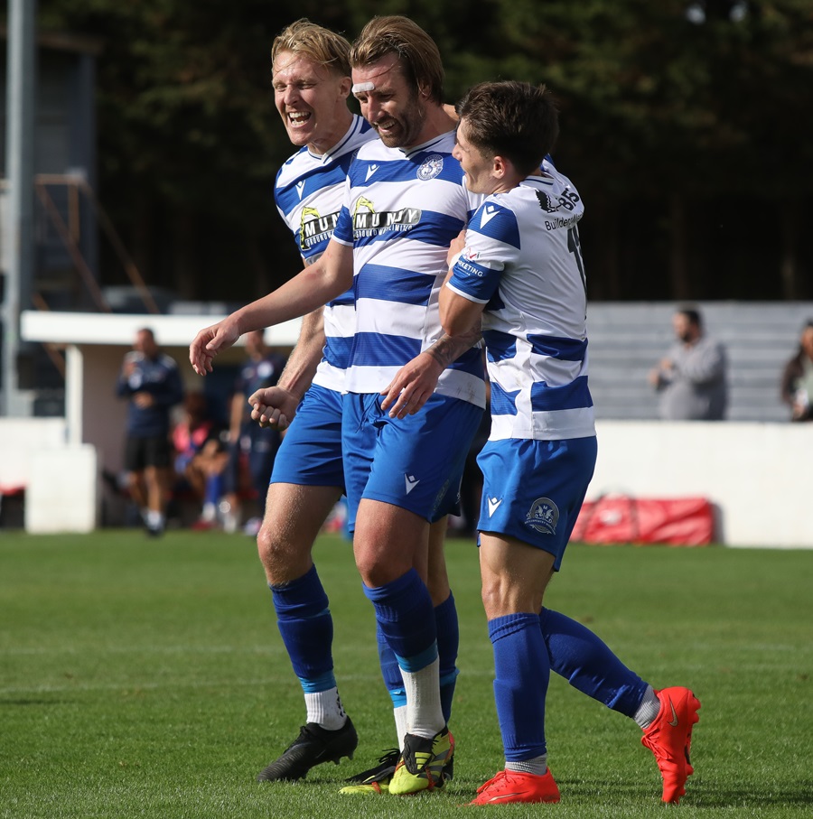 Joe Shepherd and Marcel Lewis celebrate with Conor after he scored his second goal