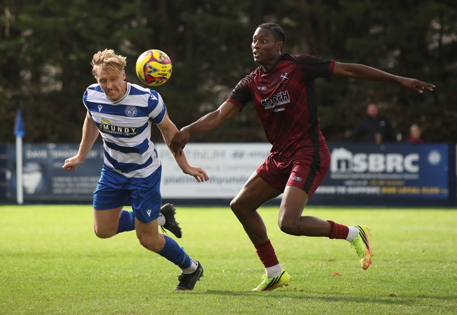 Joe Shepherd heads the ball clear