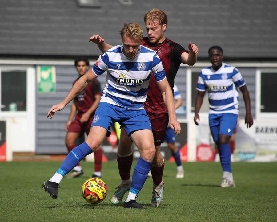 Joe Shepherd keeps the ball away from the Paulton player