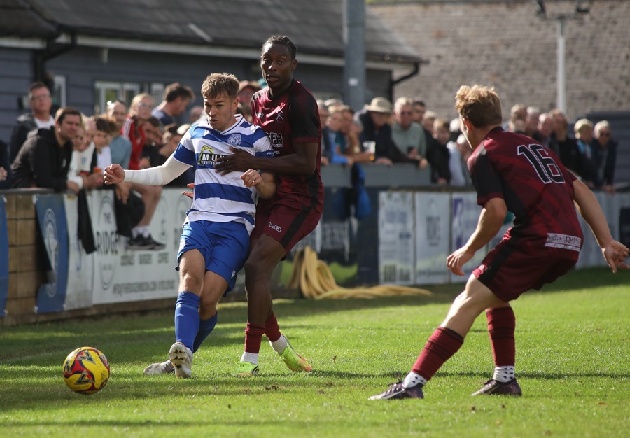 The Paulton players double up on Sam Turl who still got his pass away