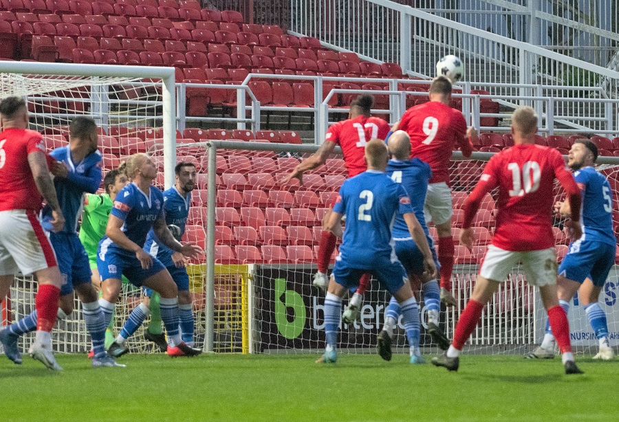 Corsham’s Gary Higdon rises the highest and heads in Corsham’s first goal