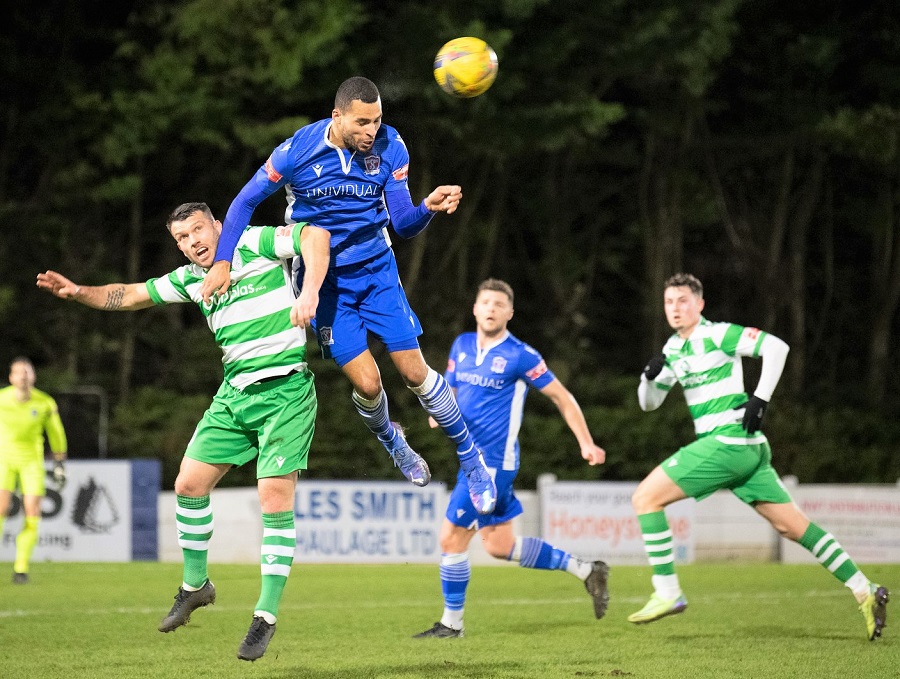 Tyrone Duffus wins the aerial battle with Merthyr’s Lewis Powell