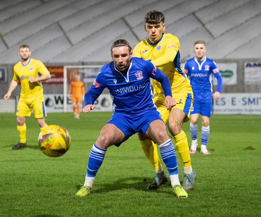 Conor McDonagh is challenge by Taunton’s Jay Foulston