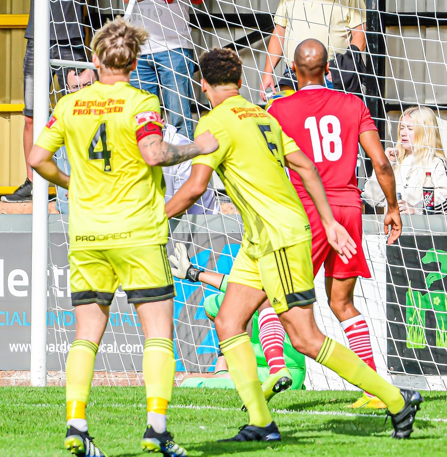 Tiverton’s Olaf Koszela scores the opening goal