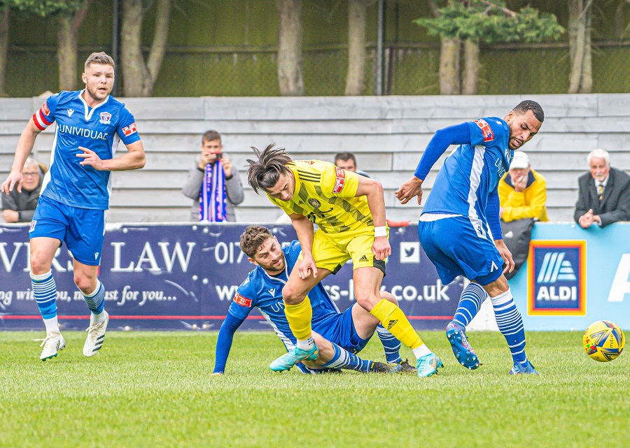Brad Hooper gets in one of many tackles against Tiverton