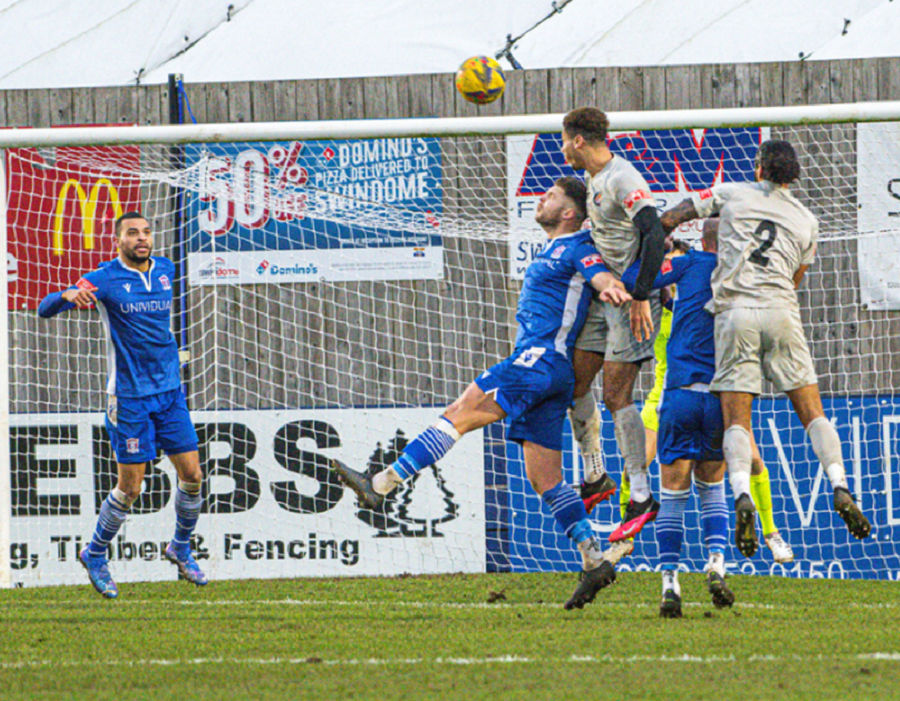 Walton’s Jerry Wiltshire gets above the Marine defence to nod home