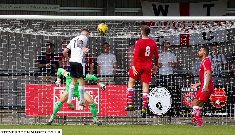 Wimborne’s Lewis Beale scores the opening goal