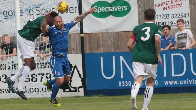 Stuart Fleetwood challenges for the ball