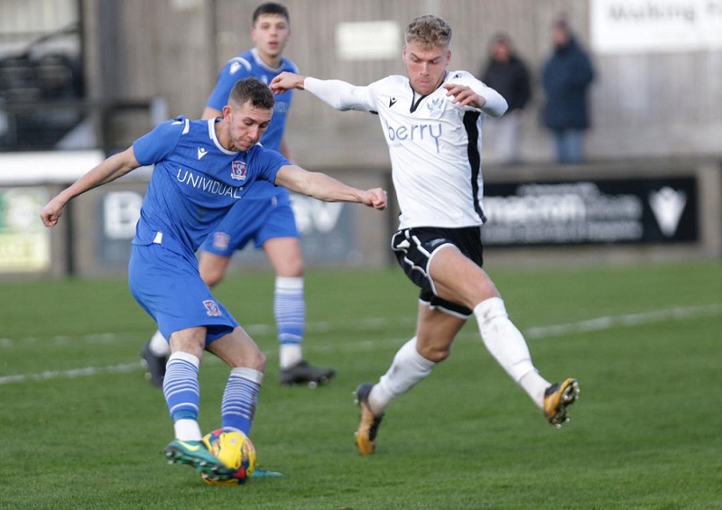 Harry Williams beats Salisbury full-back Jacob Warrell to fire home his first goal