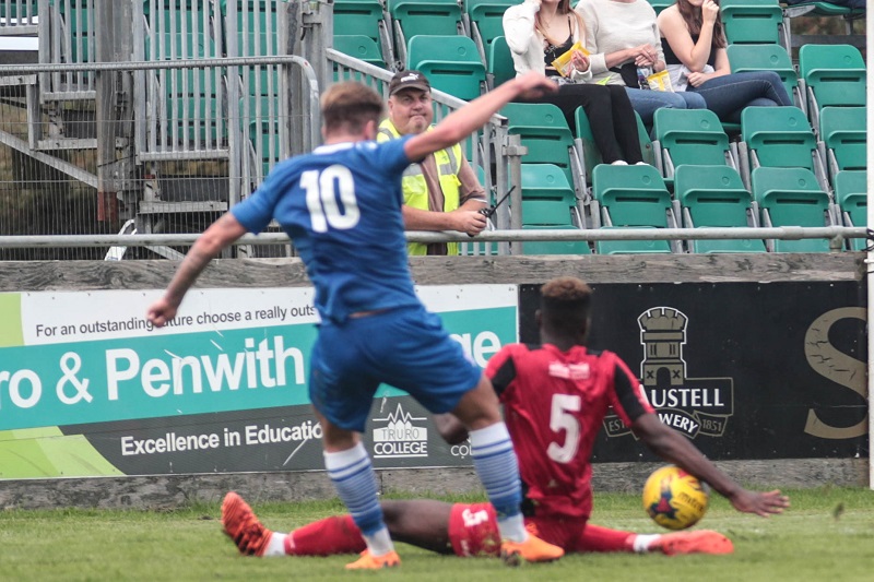 Truro defender Harlain Mbayo handles in the area