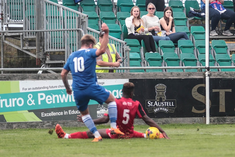 Truro defender Harlain Mbayo handles in the area