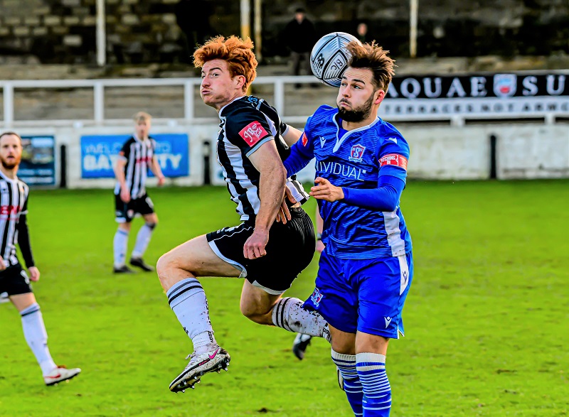 Michael Hopkins in a challenge with Bath goalscorer Tom Smith