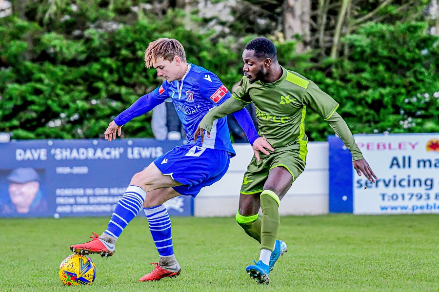 Louis Spalding defends the ball from the speedy Daniel Hector