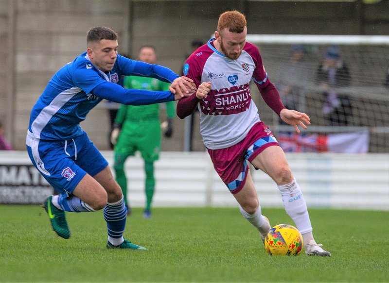 Henry Spalding challenges the Chesham player