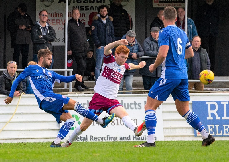 Michael Hopkins clears the ball