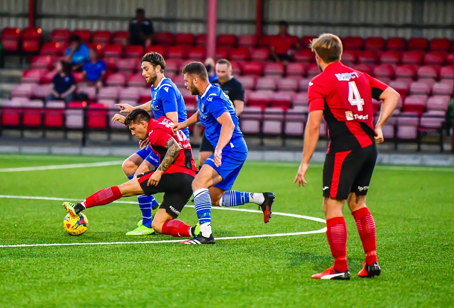 Brad Hooper & Mat Liddiard challenge for the ball at Cirencester Town