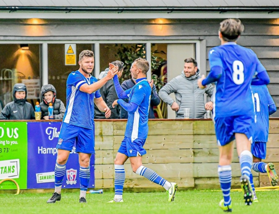 The players celebrate with Mat Liddiard after his clinching second goal