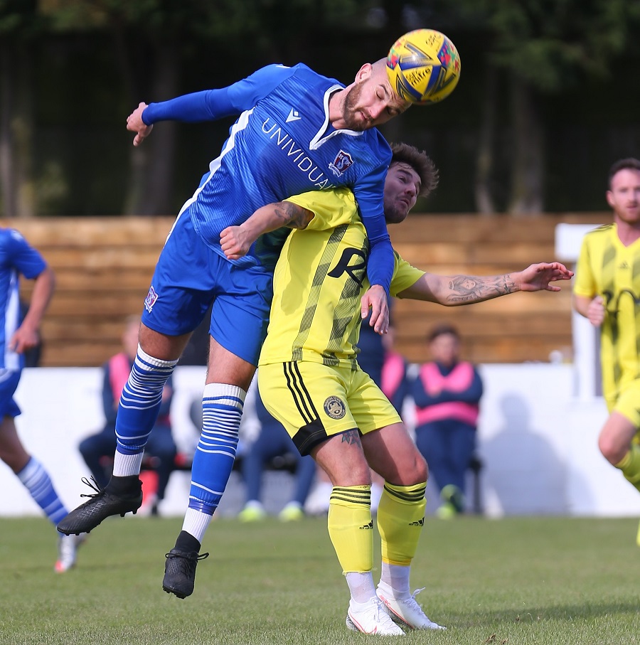 Jamie Edge wins this header against Tiverton