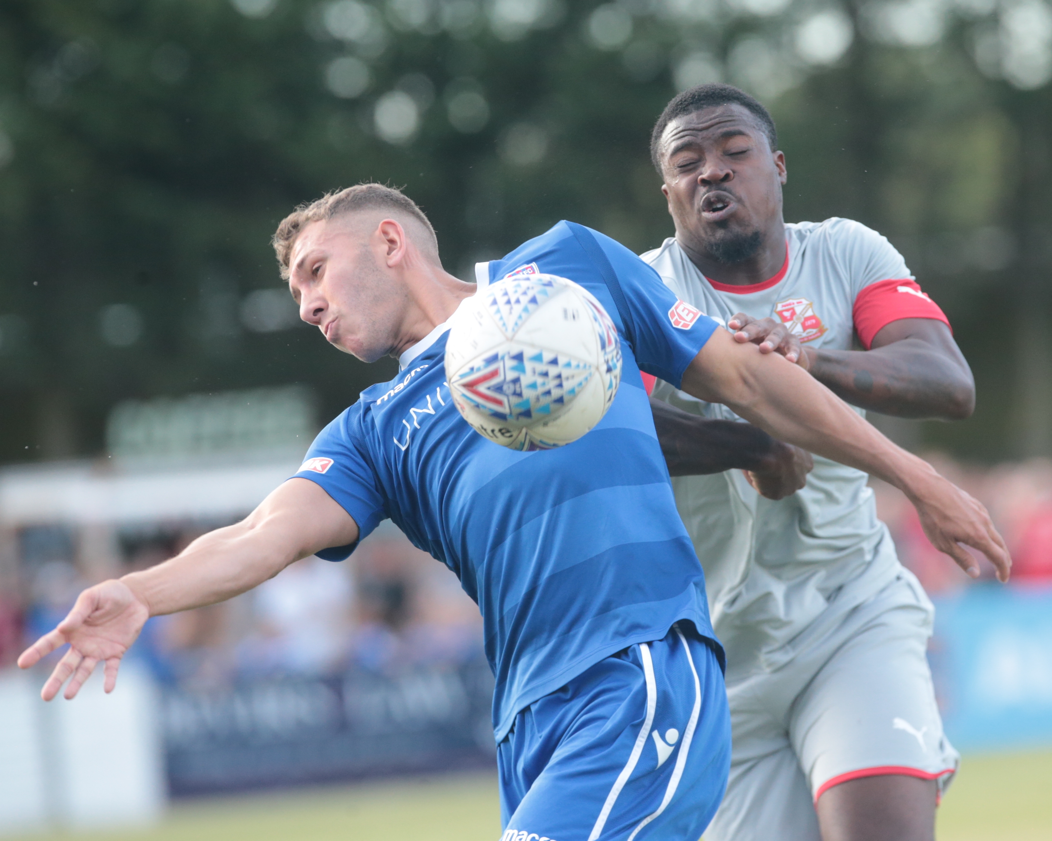 Harry Williams shields the ball from Town’s Tyler Reid